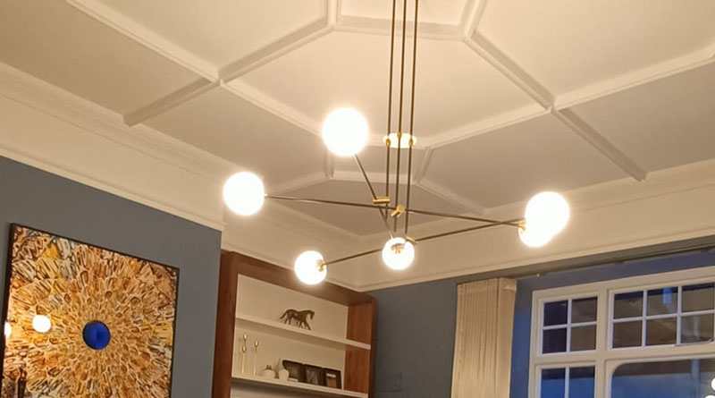 Ceiling lights with a large drop, 6 globes at the end of horizontal spokes installed by DX Electrical